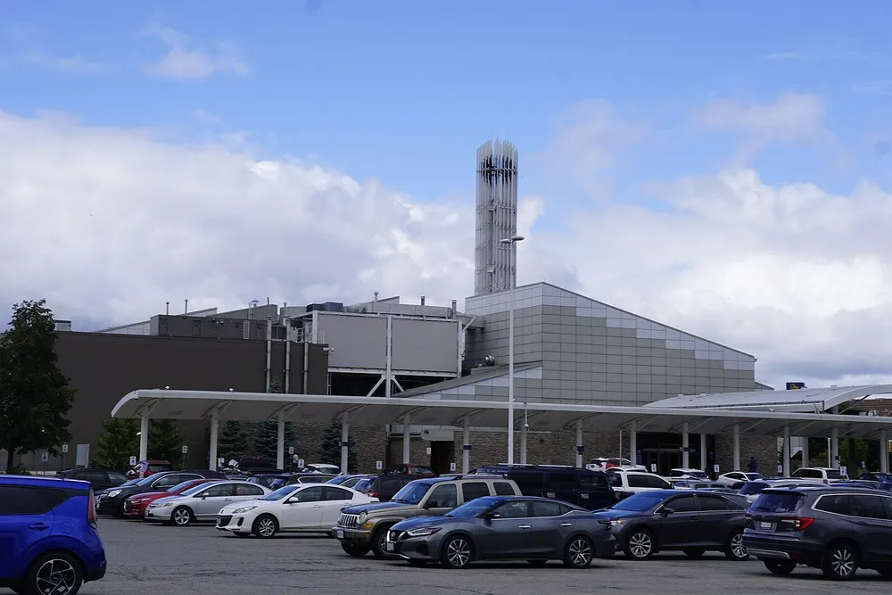 Elements Casino Brantford by day: the low casino building with its white entrance canopy beyond the parking lot